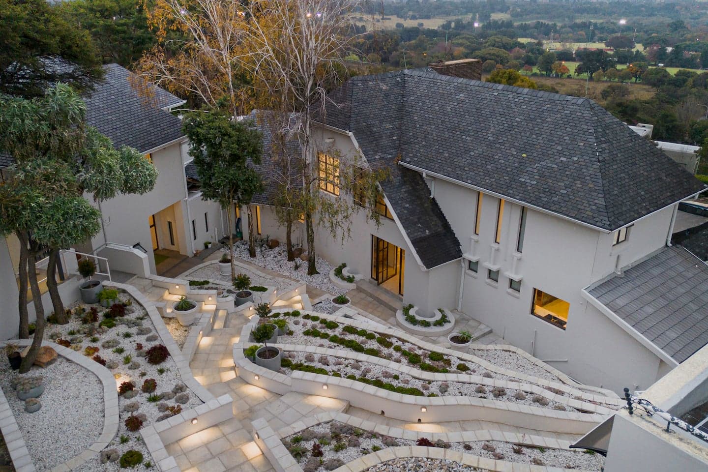 The villa lit up at dusk