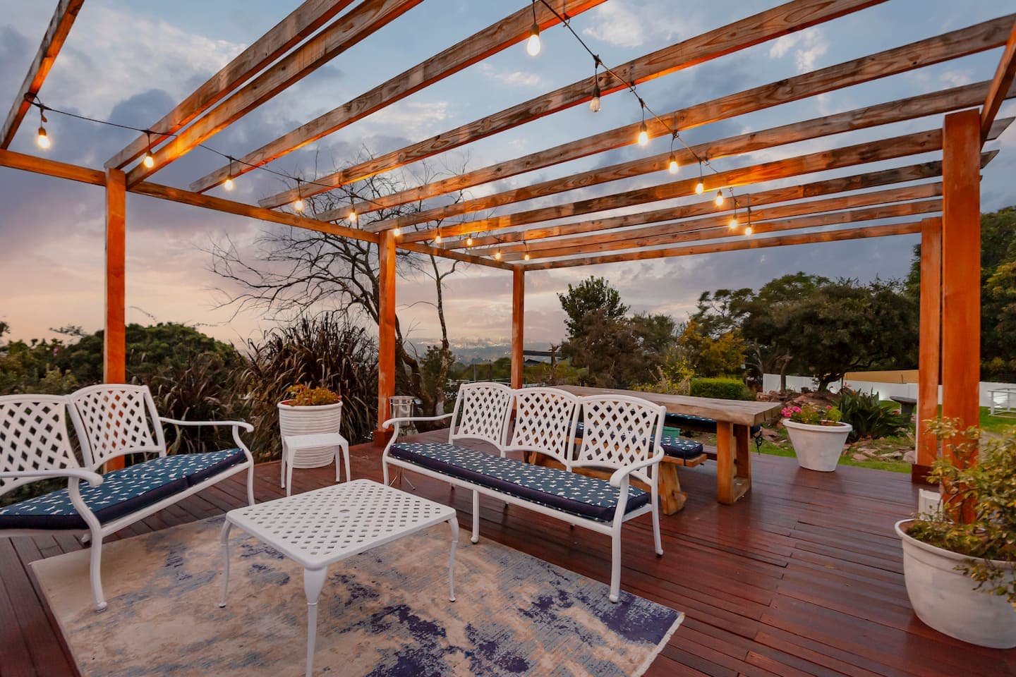 Pergola seating under string lights
